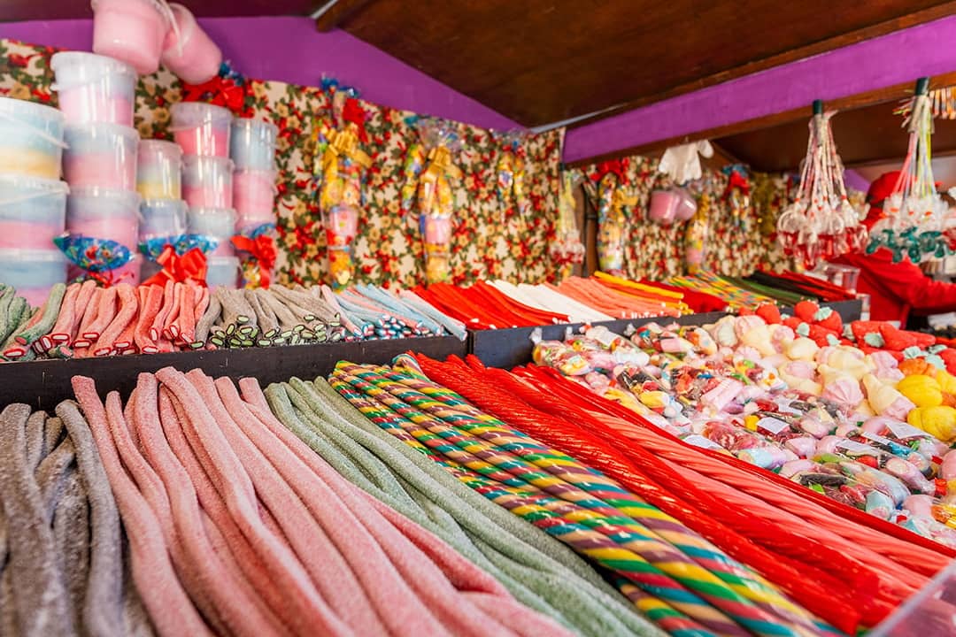 A vibrant candy stall with colorful licorice, marshmallows, and assorted sweets display.